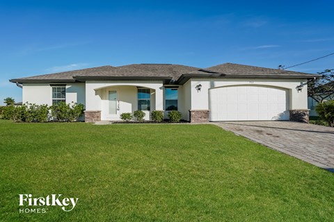 a house with a lawn and a garage door