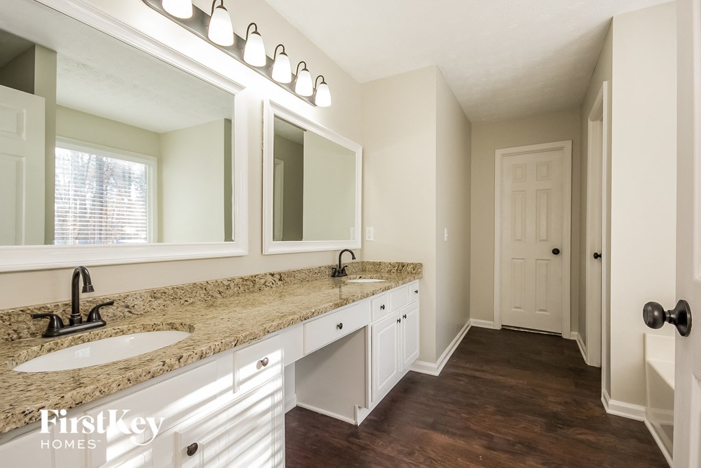 a bathroom with two sinks and a large mirror