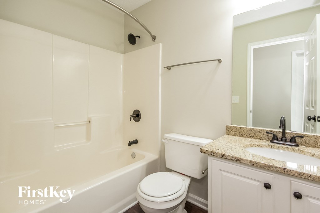 a bathroom with a sink toilet and a bath tub