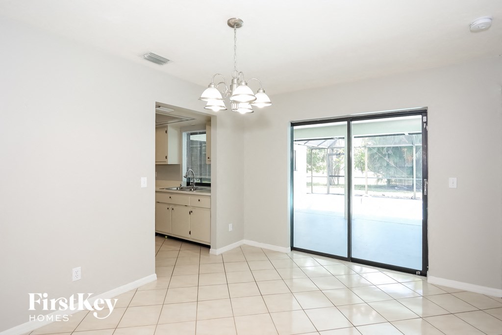 a kitchen and living room with a sliding glass door to the pool