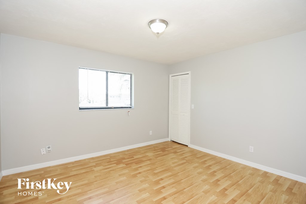 a living room with wood flooring and a window