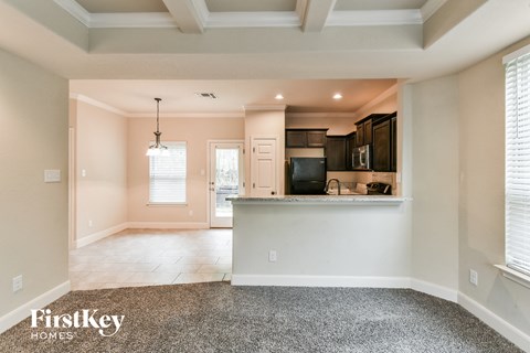 A spacious kitchen and living room with a large island in the middle.