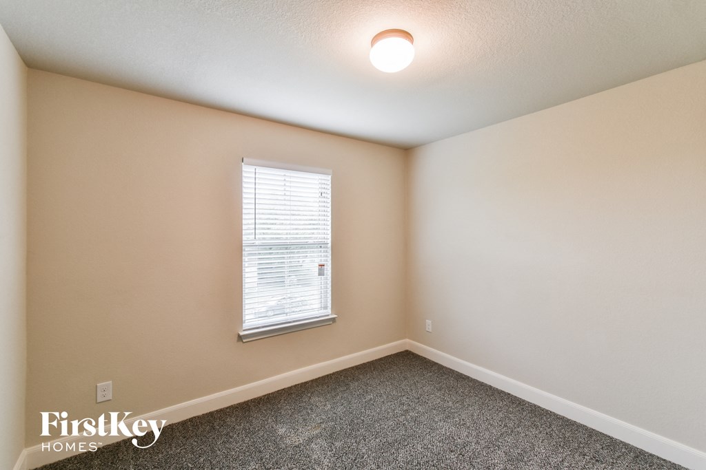 A room with a window and a FirstKey Homes logo.