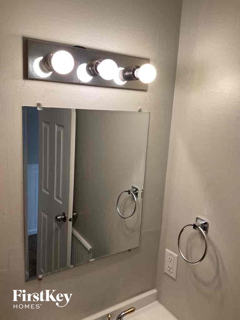a bathroom with a mirror and a light over the sink