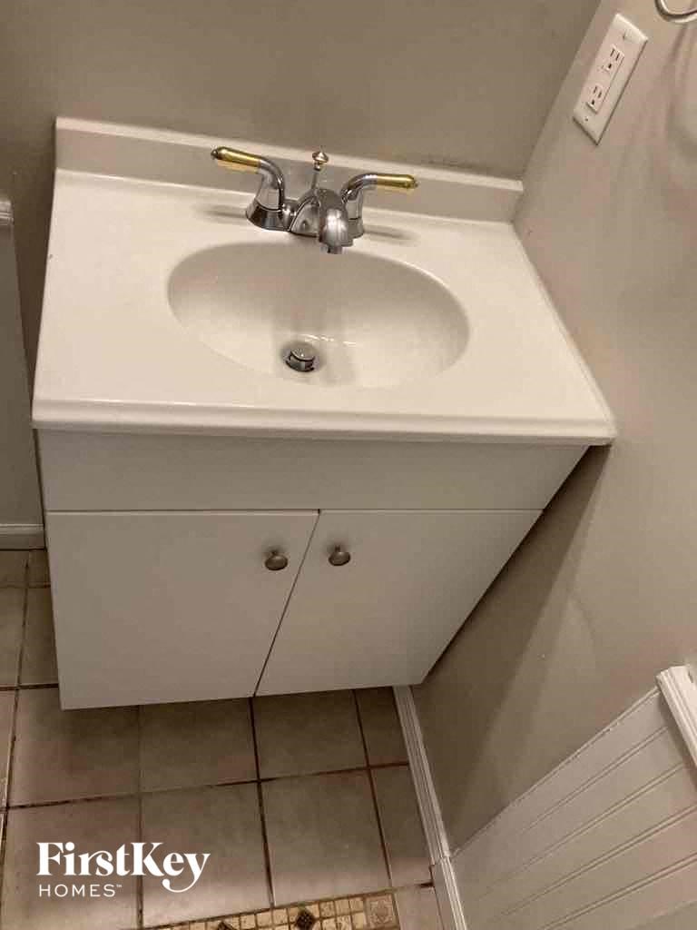a bathroom with a sink and a mirror and a toilet