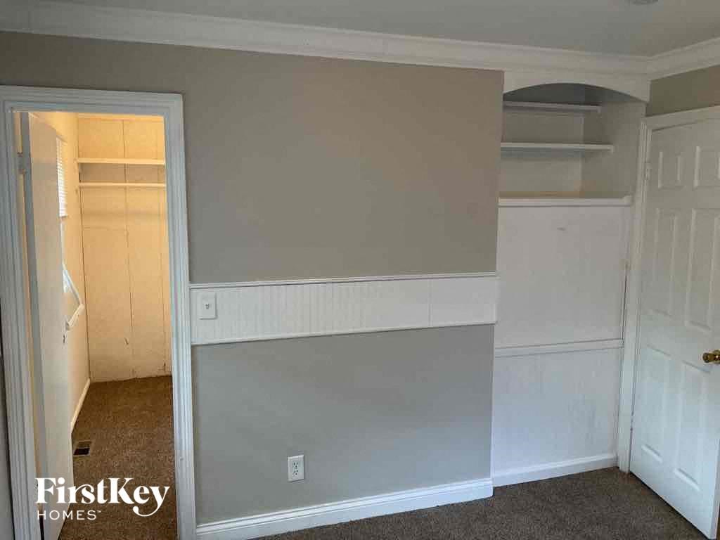 a room with a wall and a closet and a door