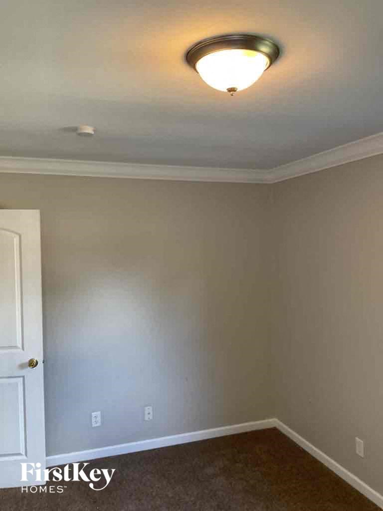 an empty room with a light on the ceiling