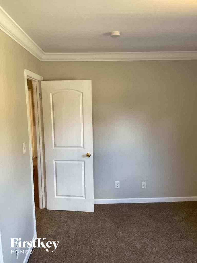 an empty room with a white door and a white wall