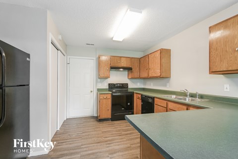 A kitchen with wooden cabinets and a green countertop.