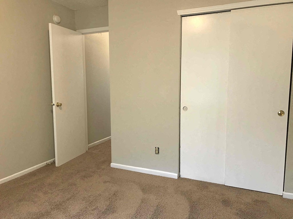 an empty room with white walls and doors