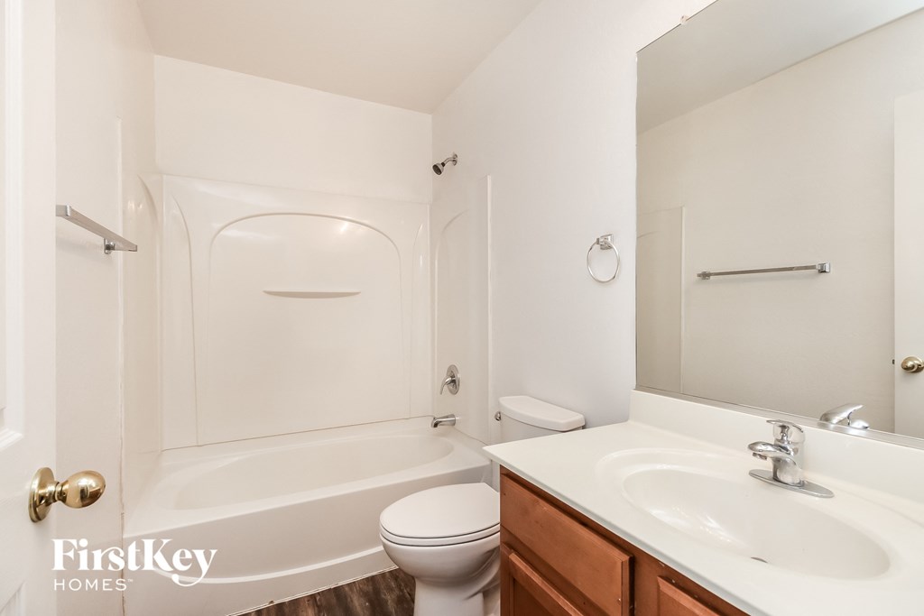 a bathroom with a sink toilet and a bath tub