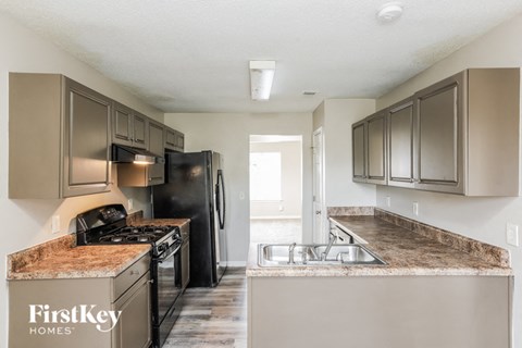 a kitchen with stainless steel appliances and granite counter tops