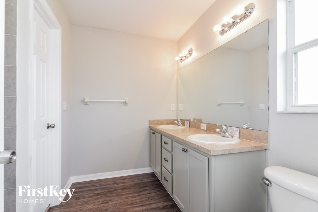 a bathroom with a sink and a mirror and a toilet