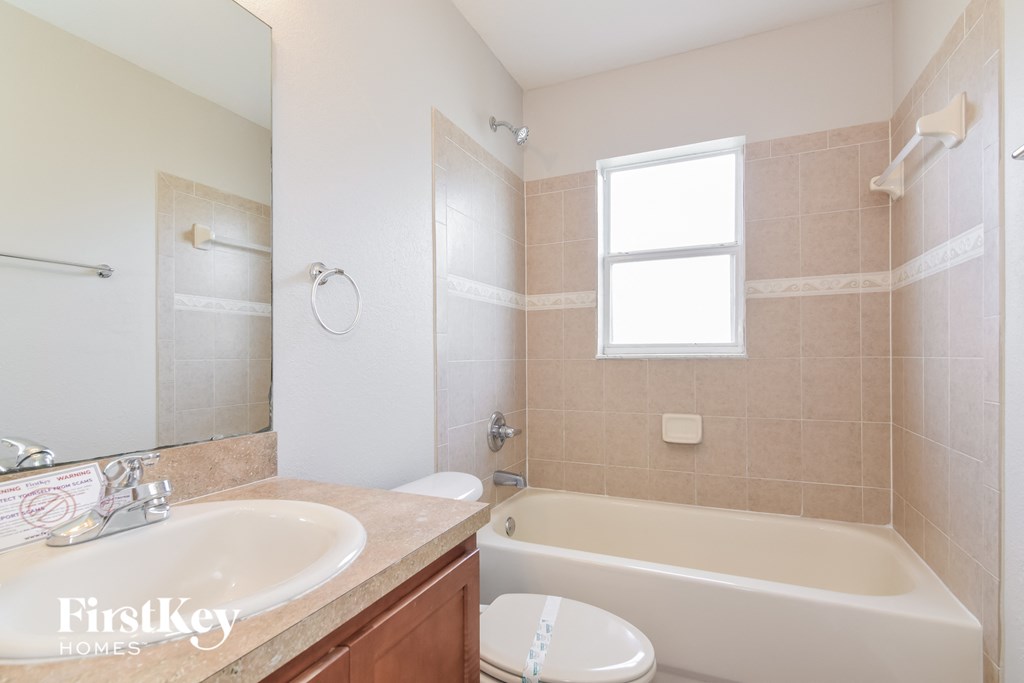 a bathroom with a tub and a sink and a toilet