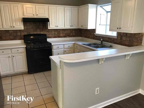 a kitchen with white cabinets and a white counter top
