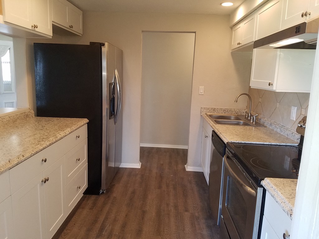 a kitchen with stainless steel appliances and white cabinets