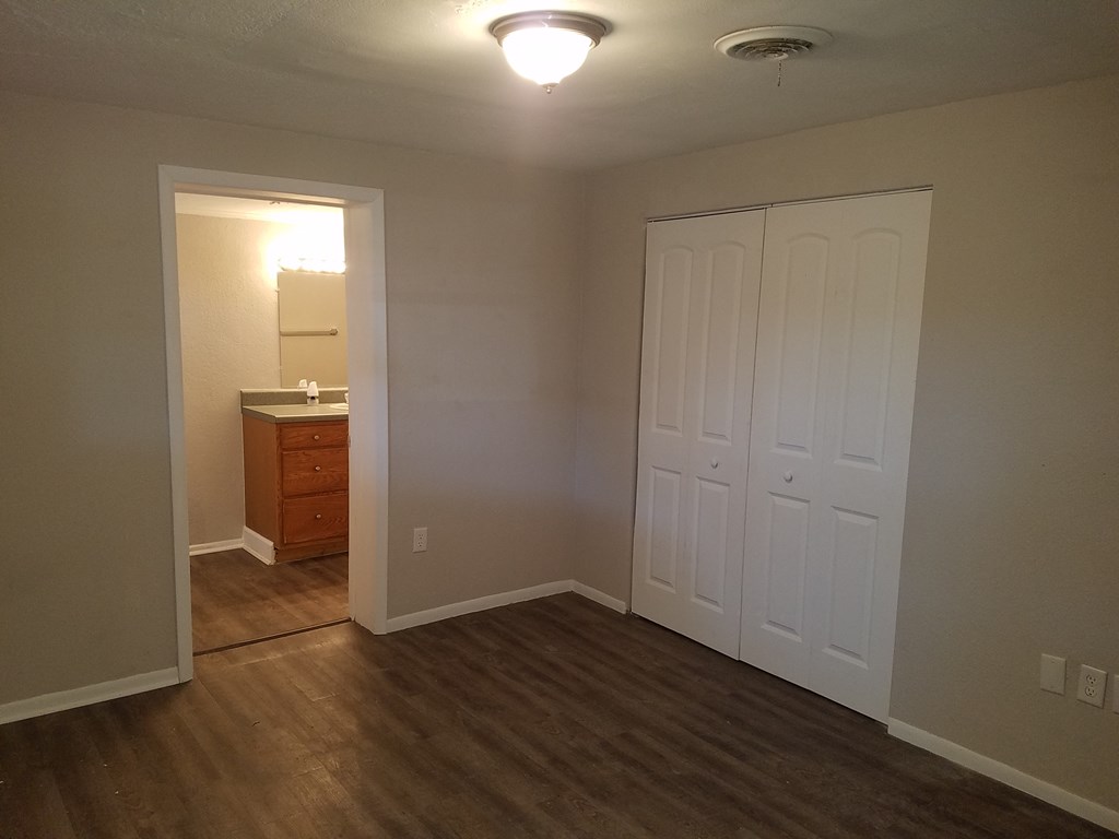a bedroom with two closets and a door to a bathroom