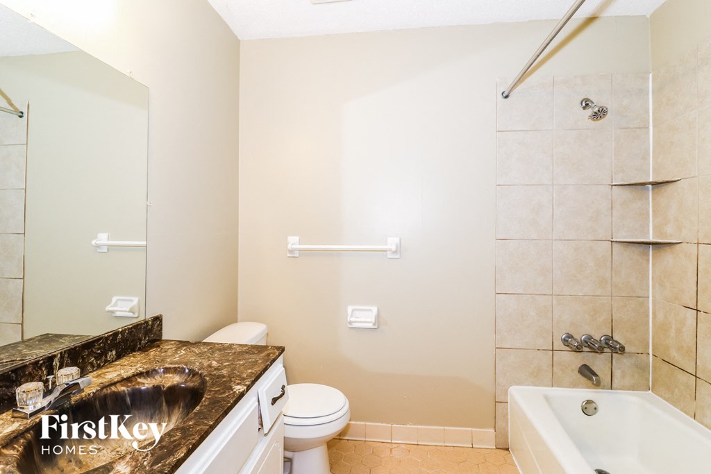 a bathroom with a sink toilet and shower and a bath tub