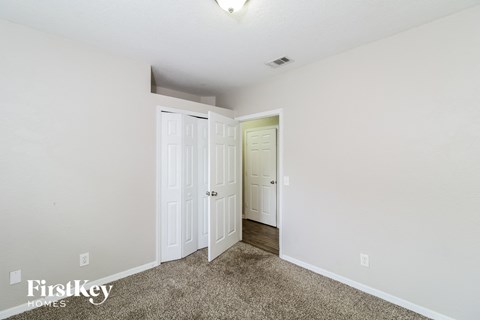 a bedroom with two closets and a door to a hallway