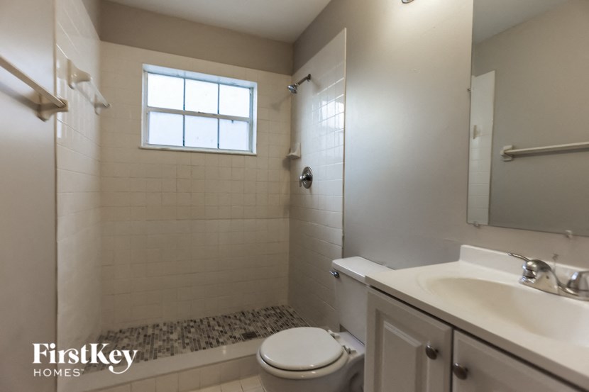 a small bathroom with a shower toilet and sink