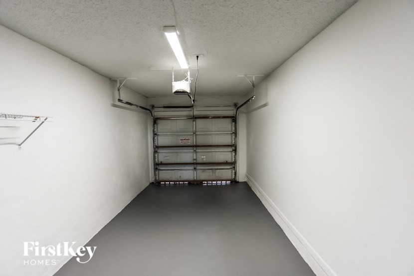 a long white hallway with white walls and a garage