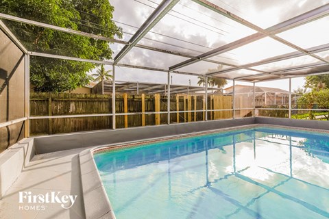 a swimming pool in a house with a glass walled pool