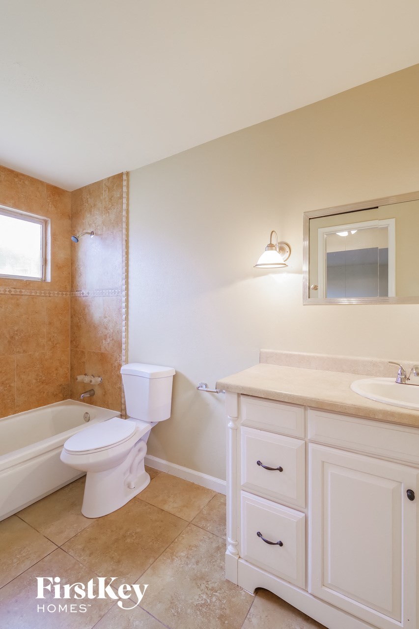 a bathroom with a toilet and a sink and a bath tub