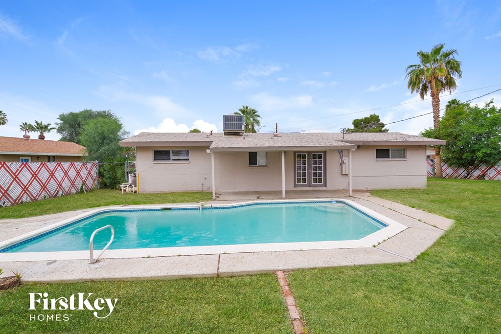 a backyard with a pool and a house
