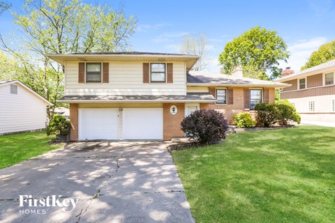 a home with a white garage door and a lawn