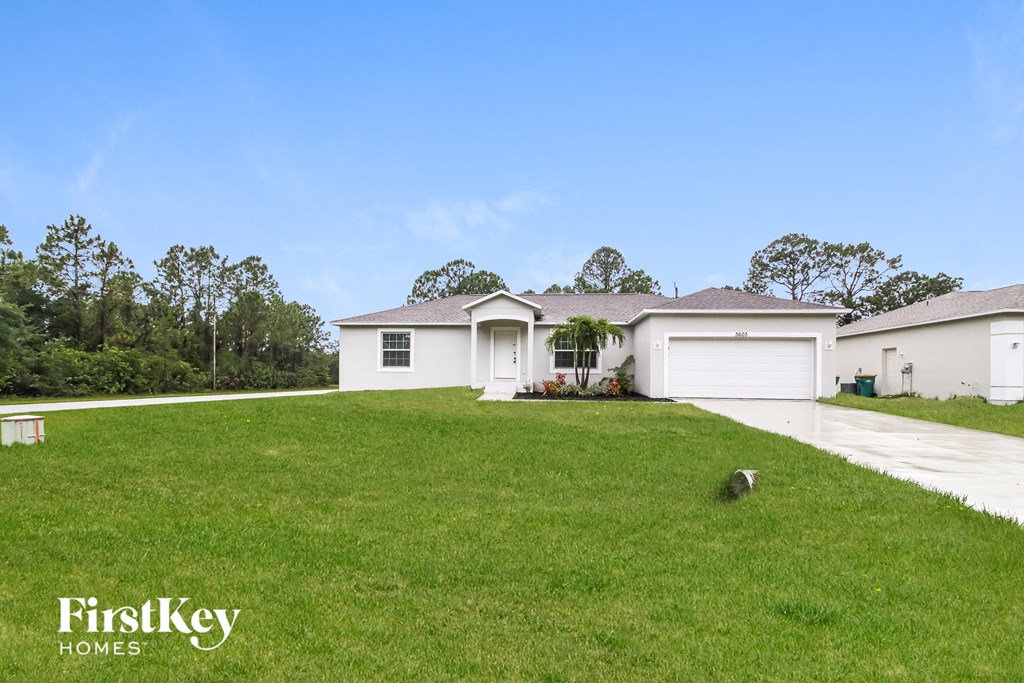 a white house with a lawn in front of it