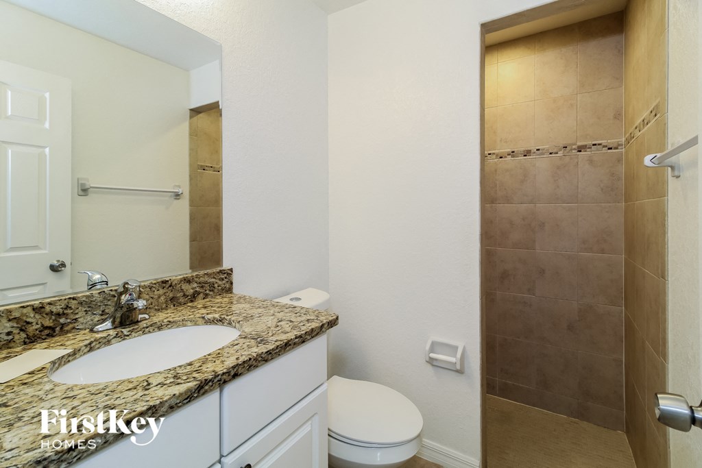 a bathroom with a sink and a toilet and a shower