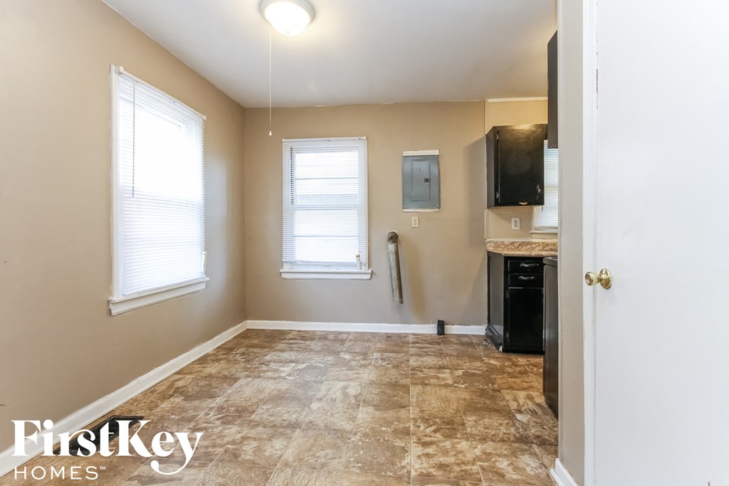 an empty kitchen and living room in a home with tile flooring