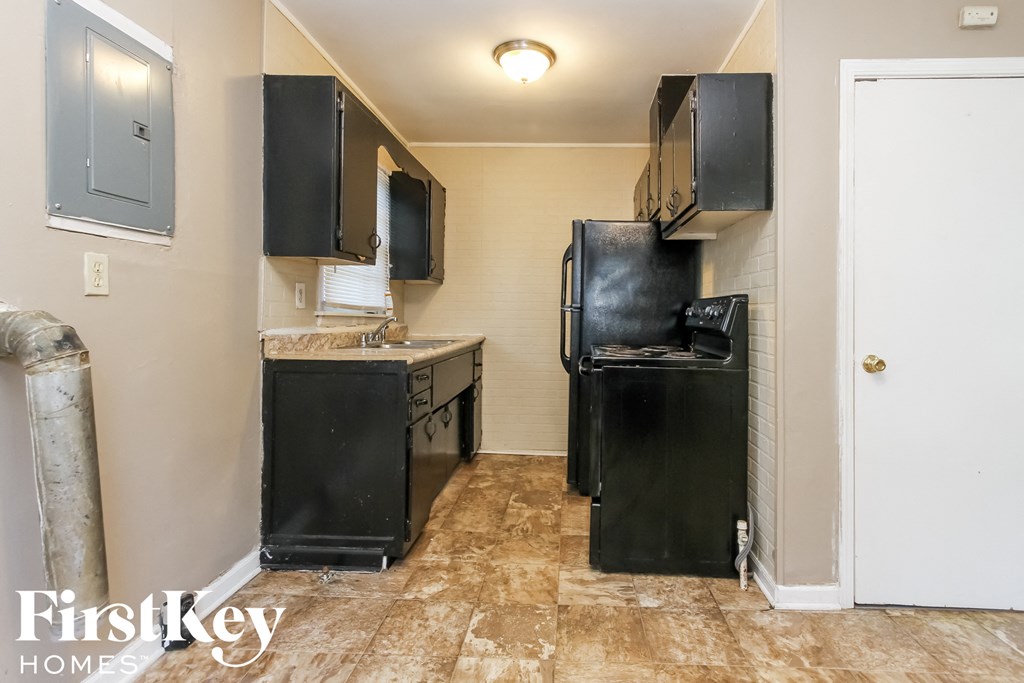 a small kitchen with a refrigerator and a sink
