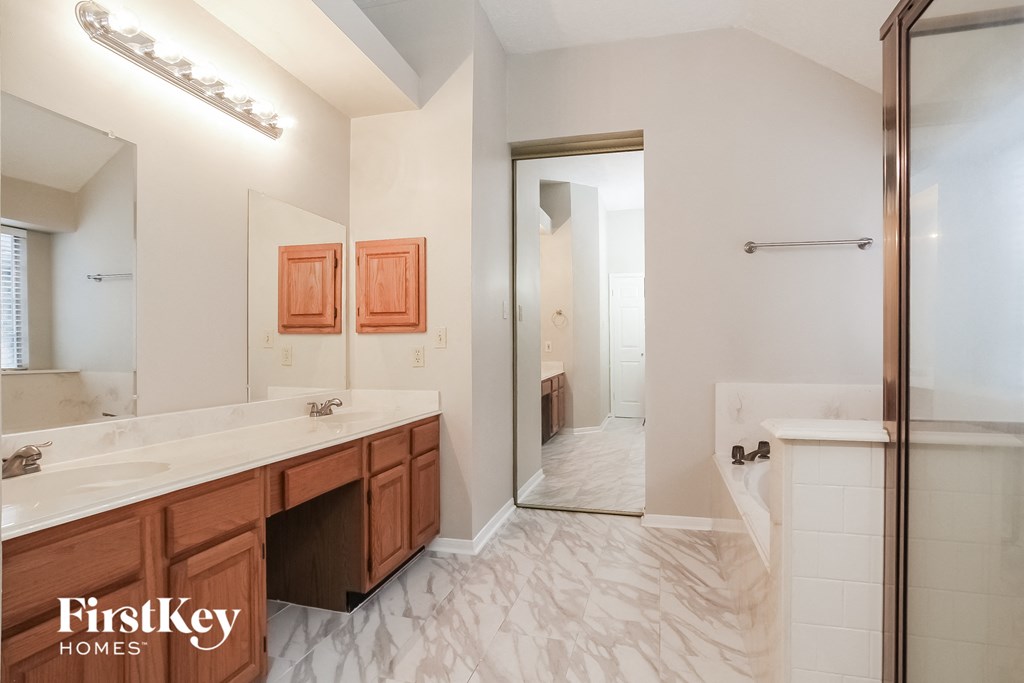 a bathroom with a shower and a sink and a mirror