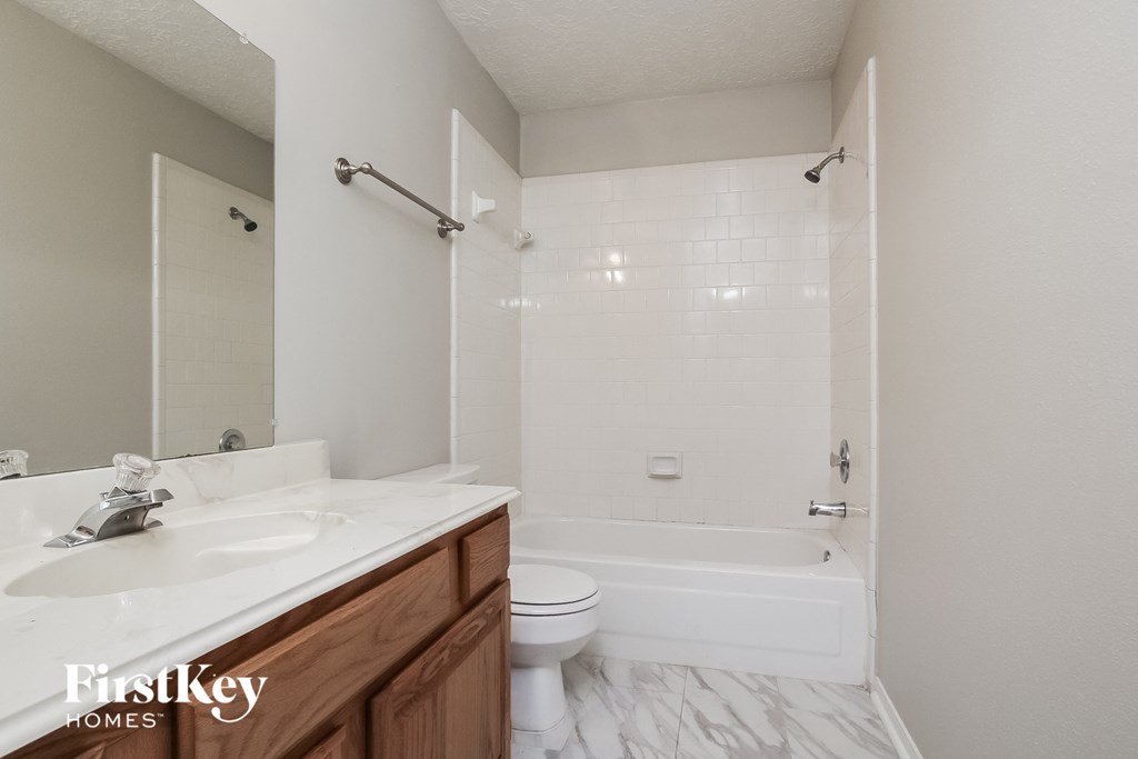 an image of a bathroom with a sink toilet and shower