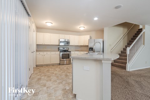 a kitchen with white cabinets and a counter top