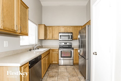 a kitchen with wooden cabinets and stainless steel appliances
