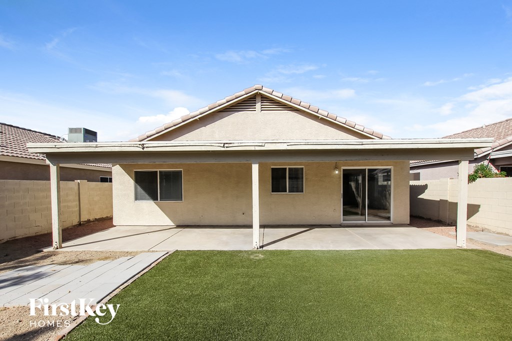 a white house with a lawn and a patio