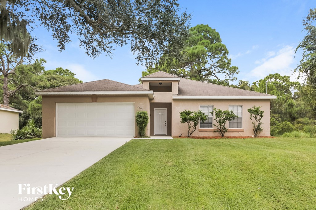 a home with a lawn and a garage