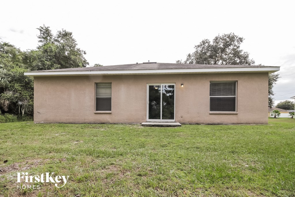 the front of a small brick house with a grassy yard