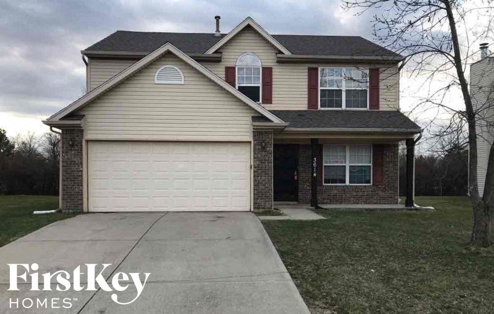 A house with a garage and a driveway is shown.