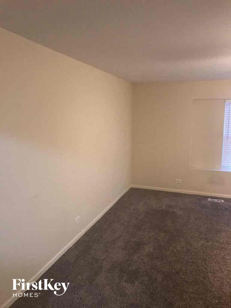 a room with a carpeted floor and a window