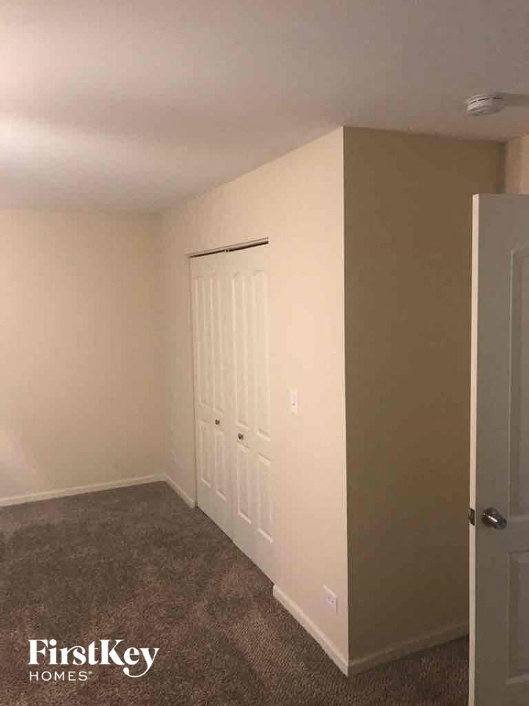 an empty room with a closet and a door