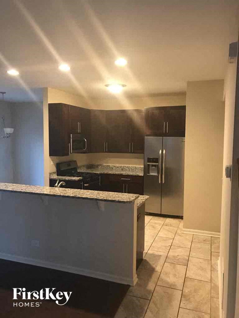 a kitchen with a counter top and a refrigerator