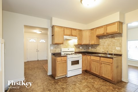 a kitchen with wooden cabinets and a white stove