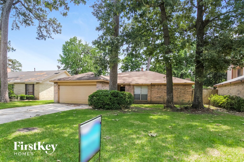 a home with a sign in the yard and trees
