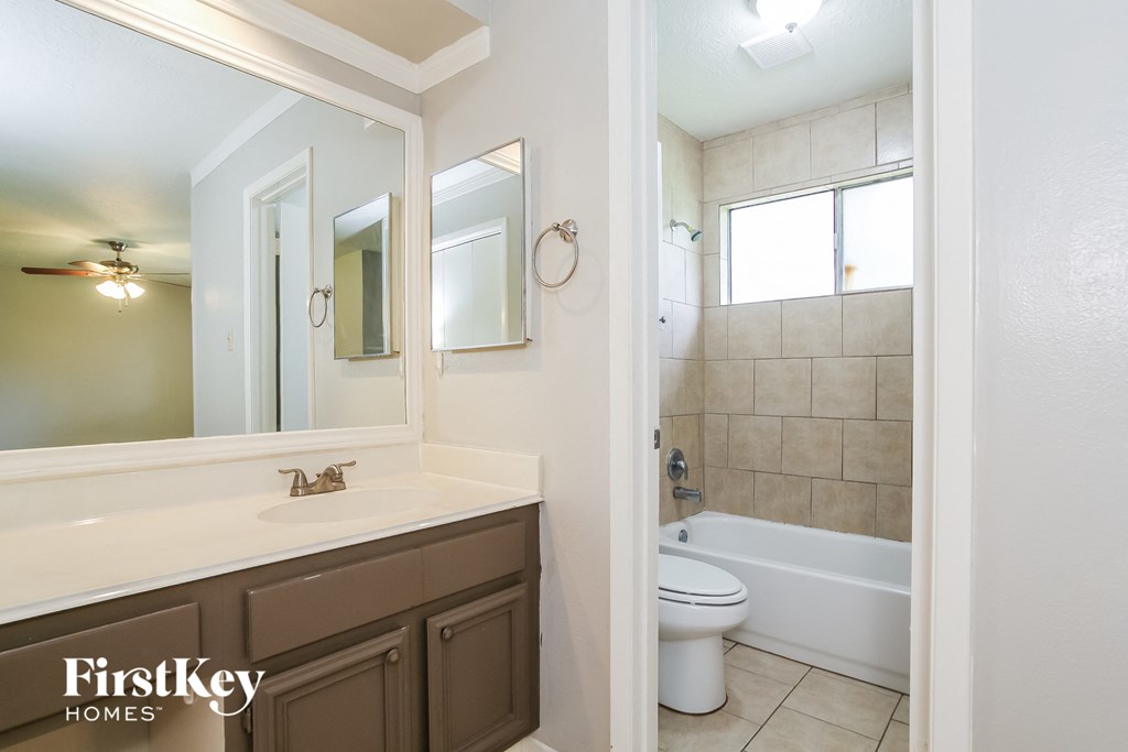 a bathroom with a toilet and a sink and a mirror