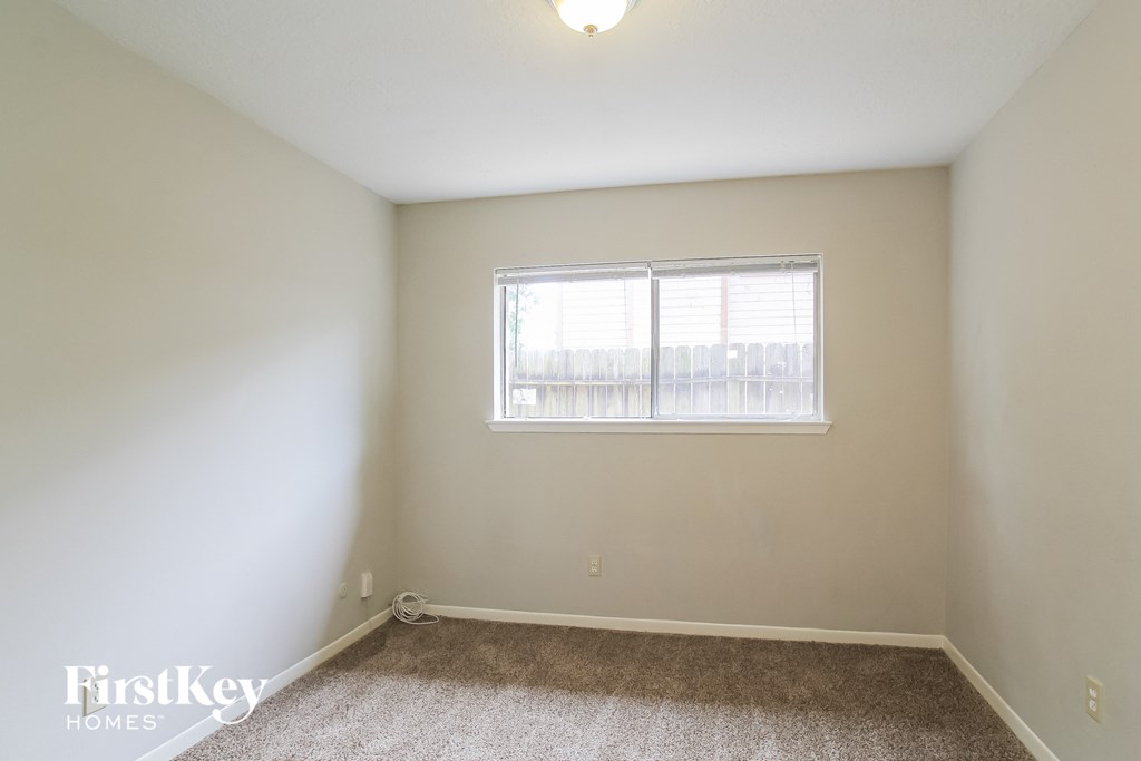 the living room of an empty house with a window