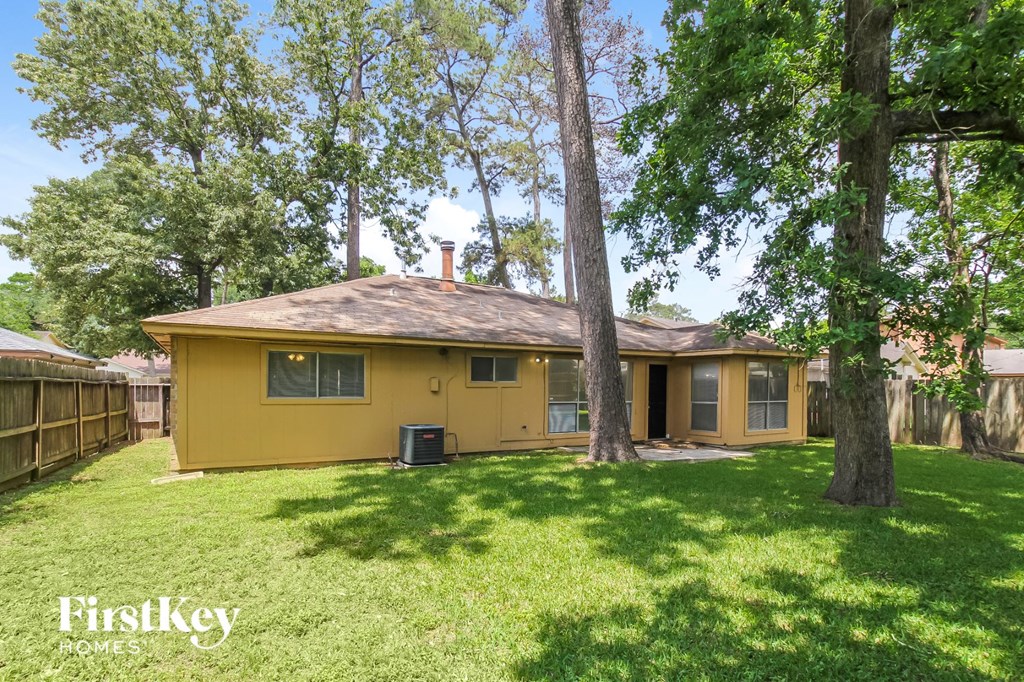 a yellow house with a yard and trees