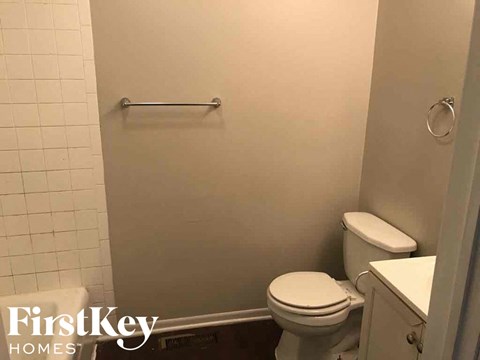 a small bathroom with a toilet and a towel rack
